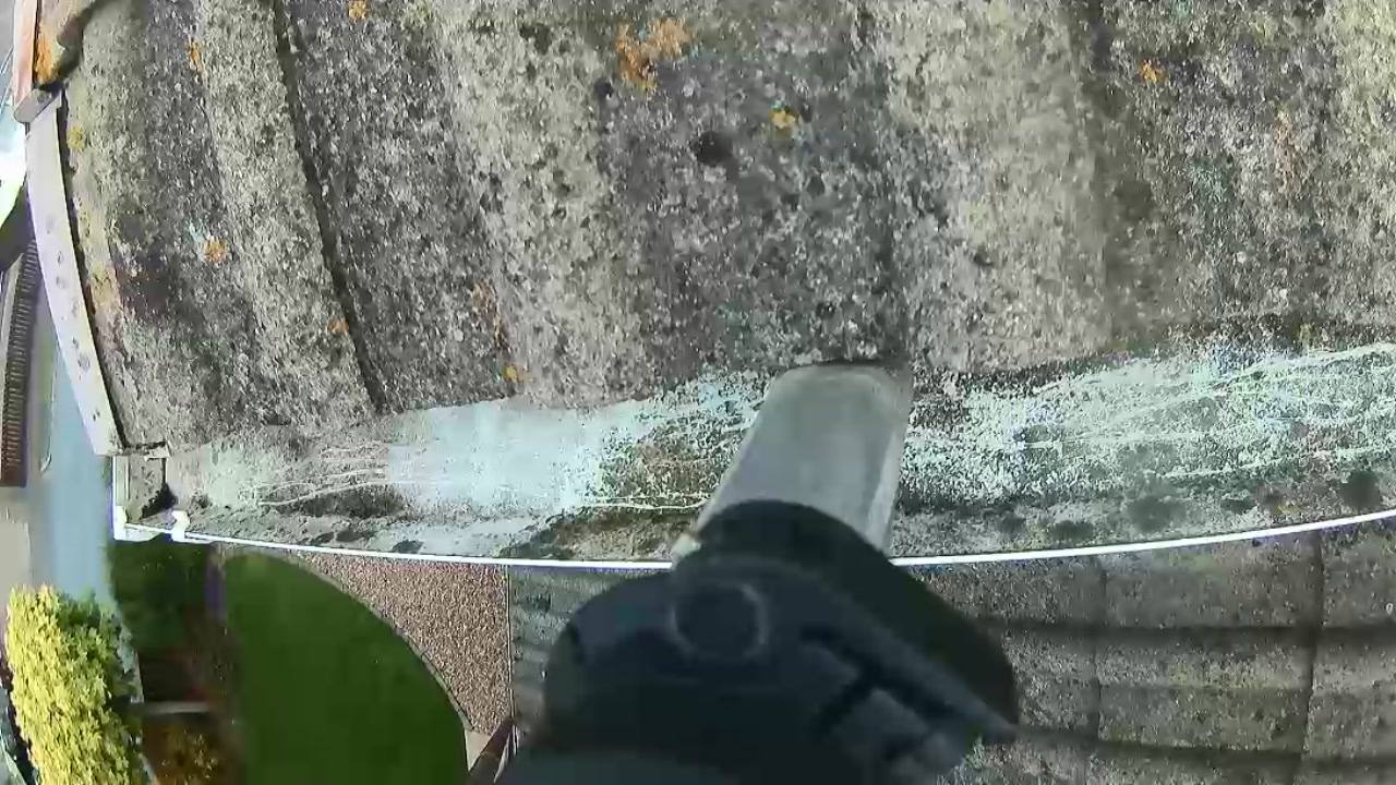 Gutter installation work on a stone wall